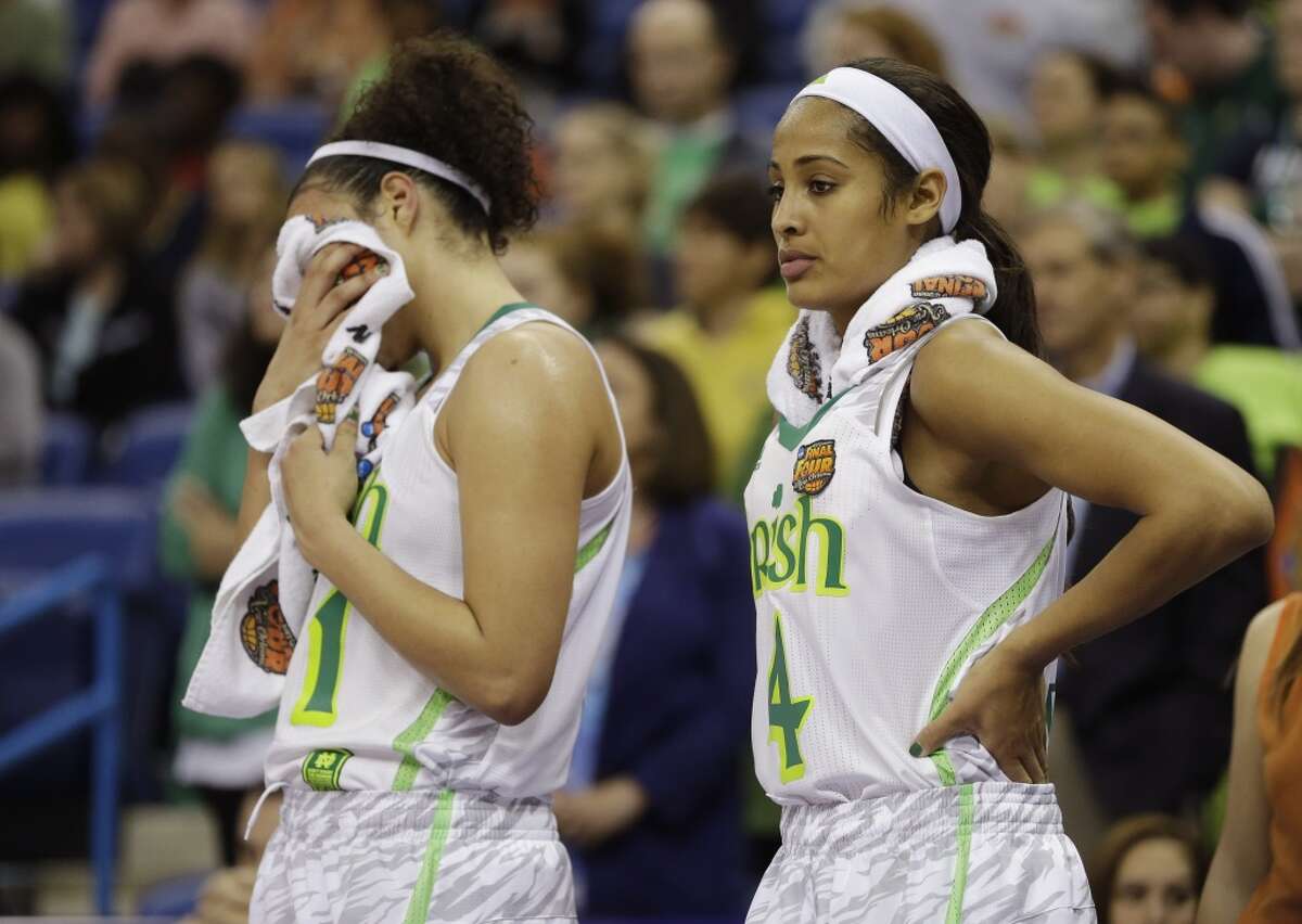 Notre Dame guard Kayla McBride (21) and guard Skylar Diggins (4) react at the end of the women's NCAA Final Four college basketball tournament semifinal Connecticut, Sunday, April 7, 2013, in New Orleans. UConn won 83-65. (AP Photo/Gerald Herbert)