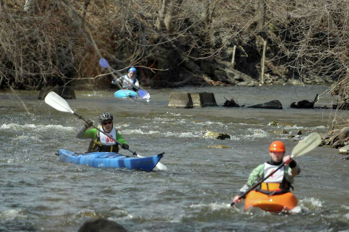 Kayakers, Howard Layer, left, and Pat Sleasman, right, make their way down the course during the 40th running of the Tenandeho Boat Races on Sunday, April 7, 2013 in Mechanicville, NY. The races is open to kayaks, solo canoes, tandem canoes, and polers. Rescue volunteers were positioned after most of the big rapids in the course. (Paul Buckowski / Times Union)