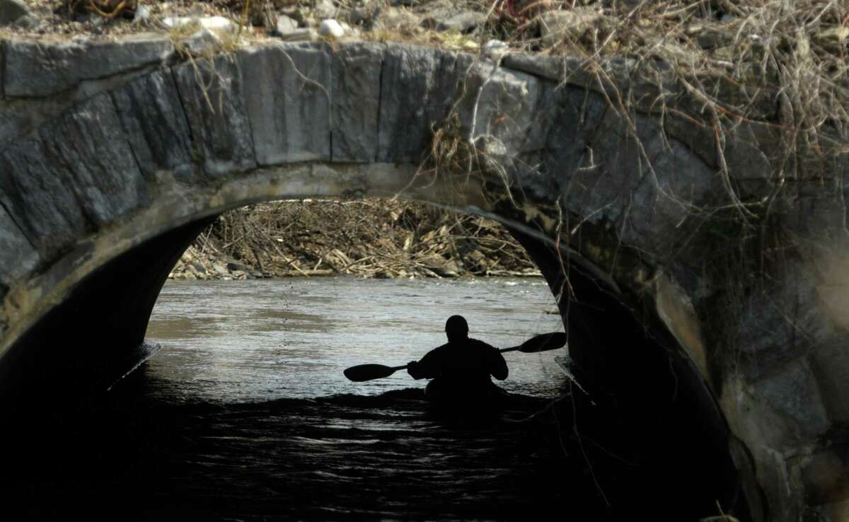 A kayaker goes under the Central Ave. bridge during the 40th running of the Tenandeho Boat Races on Sunday, April 7, 2013 in Mechanicville, NY. The races is open to kayaks, solo canoes, tandem canoes, and polers. Rescue volunteers were positioned after most of the big rapids in the course. (Paul Buckowski / Times Union)