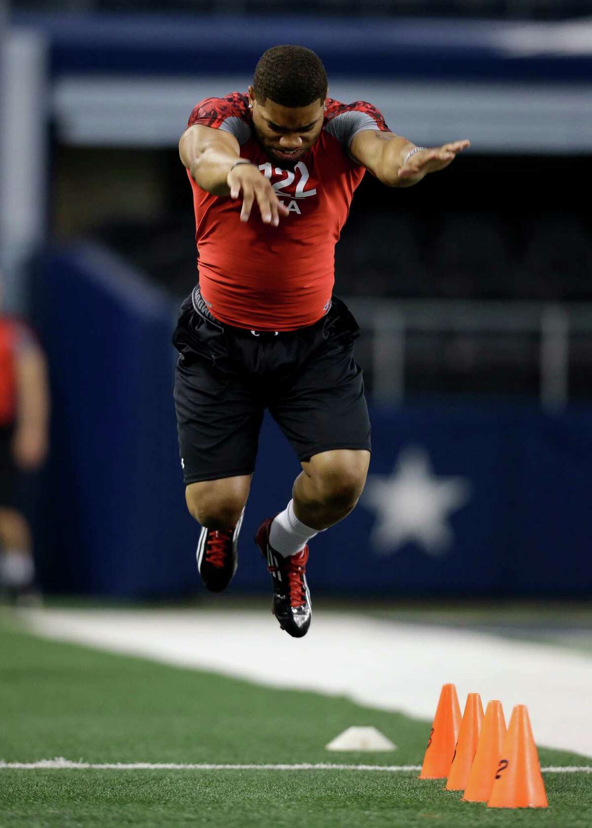 B.J. Daniels leaps forward during the broad jump at the NFL super regional football combine Monday, April 8, 2013, in Arlington, Texas. (AP Photo/Tony Gutierrez)