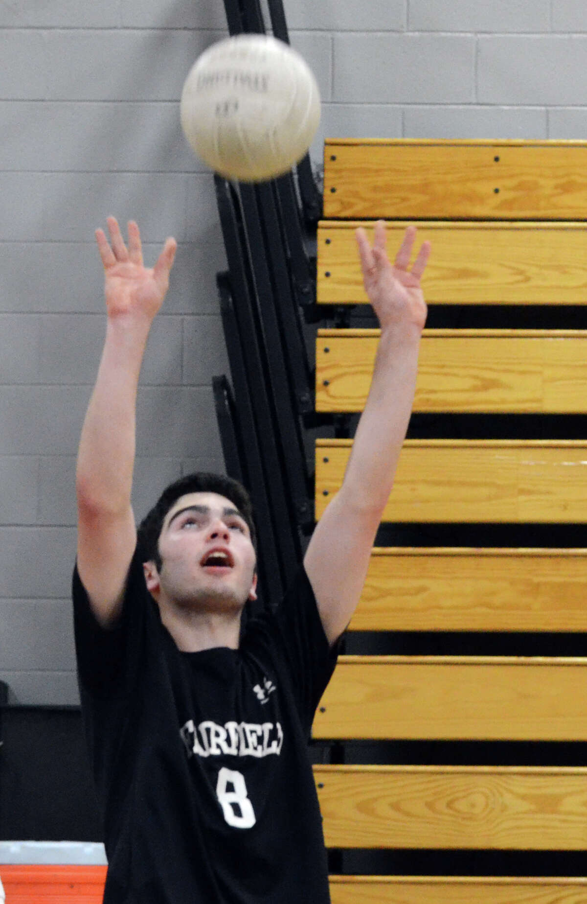 Fairfield's Alec Gropman sets the ball during the coop boys volleyball game against Bassick at Fairfield Ludlowe on Monday, May 2, 2011.