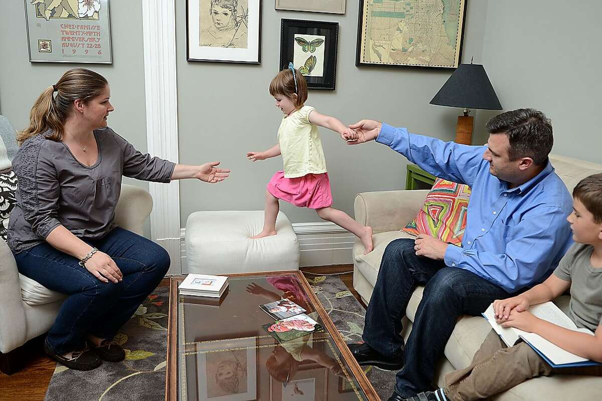 Vale Cervarich, age 37, and her husband, Mark, age 42, play with their daughter Lucy, age 3, as their son, Oscar, age 7, watches while at their home on April 4, 2013 in San Francisco, Calif. The Cervarich's daughter, Ava, died of a soft-tissue sarcoma when she was 1 years old.