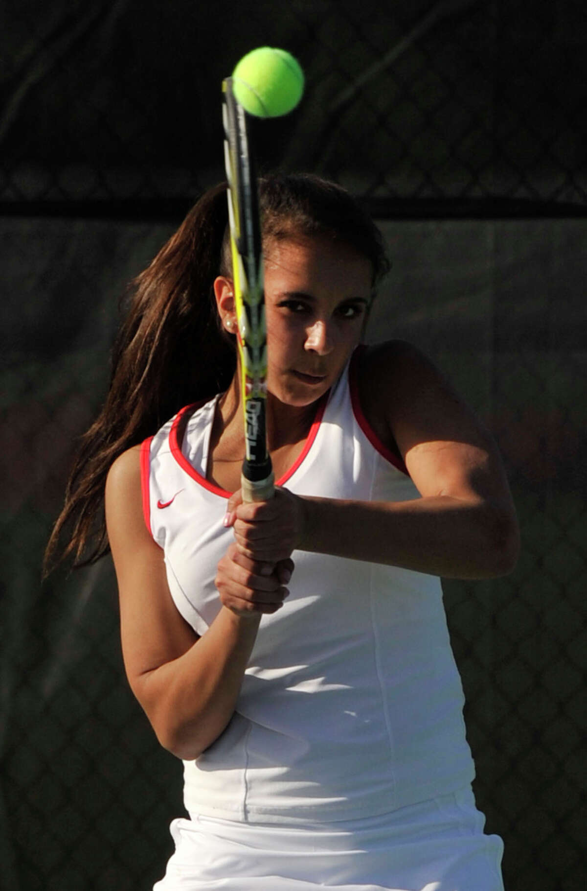 Greenwich's Julia Hyland follows through on her return to the New Canaan side during their doubles tennis match at New Canaan High School on Tuesday, April 9, 2013.