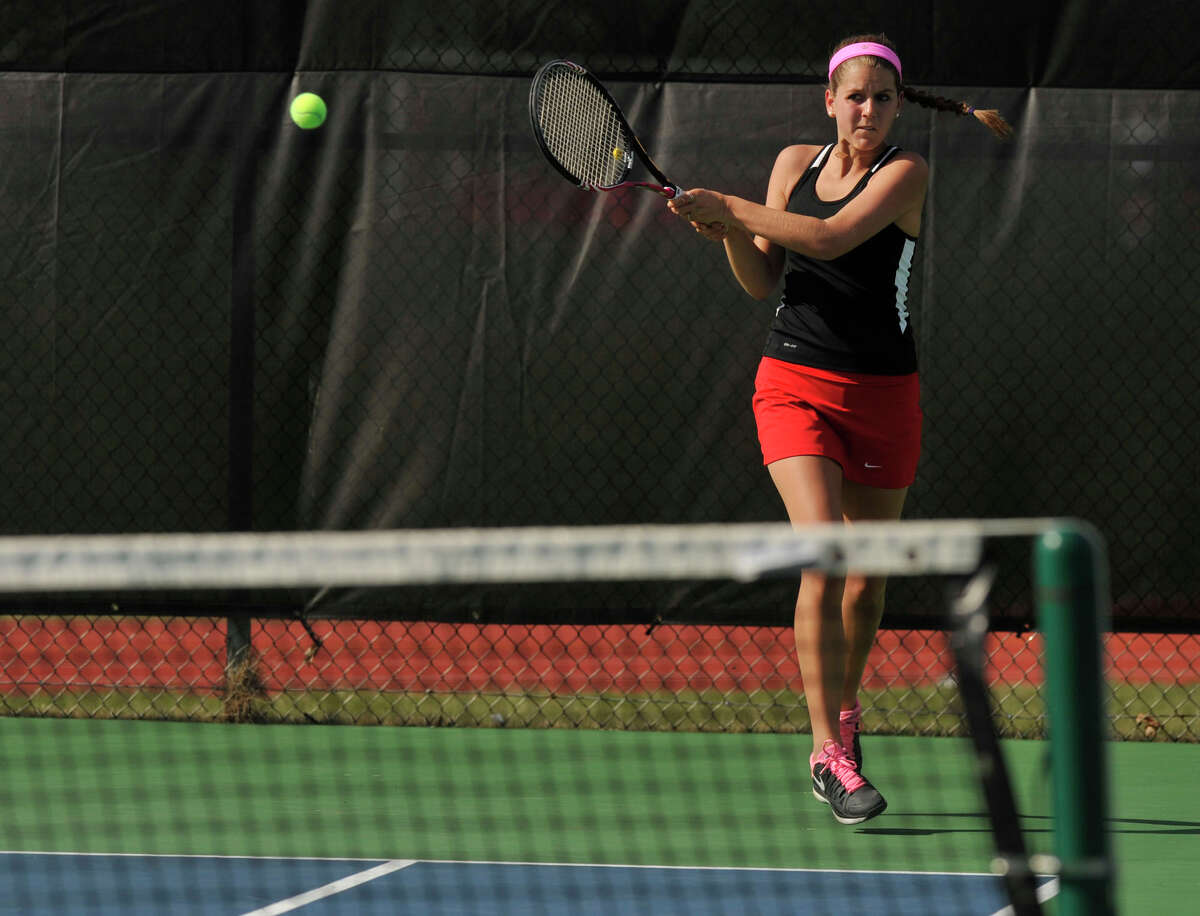 New Canaan's Kristin Laub returns the ball to the Greenwich side during their doubles tennis match at New Canaan High School on Tuesday, April 9, 2013.