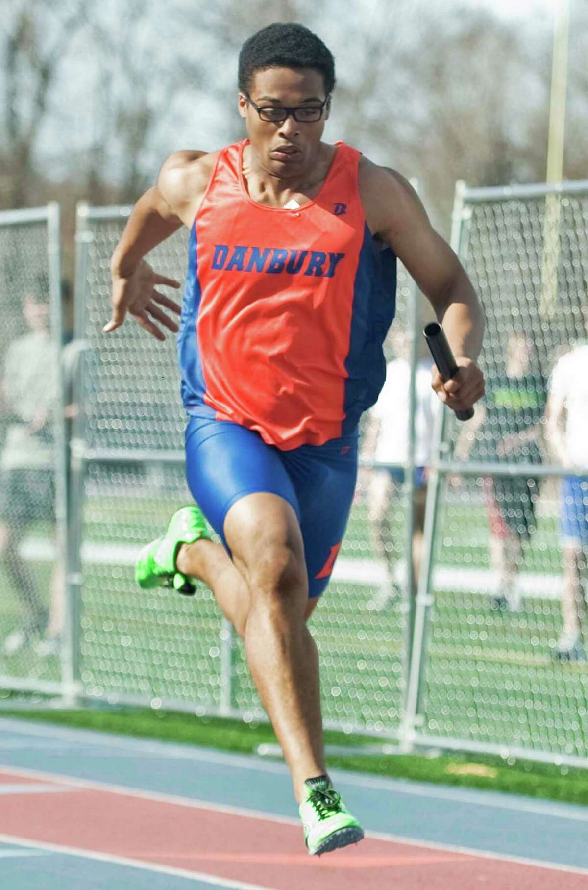 Danbury High School senior Micaiah Hill comes to the line in the 4X100 relay in the boys track meet at Danbury. Tuesday, April 9, 2013