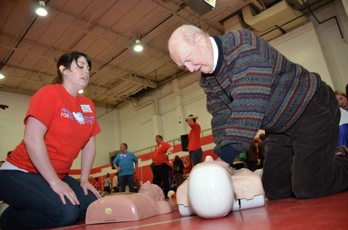 An event for all ages, Joe Kelley gets some instruction and learns Hands Only CPR from Kyna Delaney at the Hands For Life New Canaan event held at the New Canaan YMCA on Sunday, April 7, 2013.