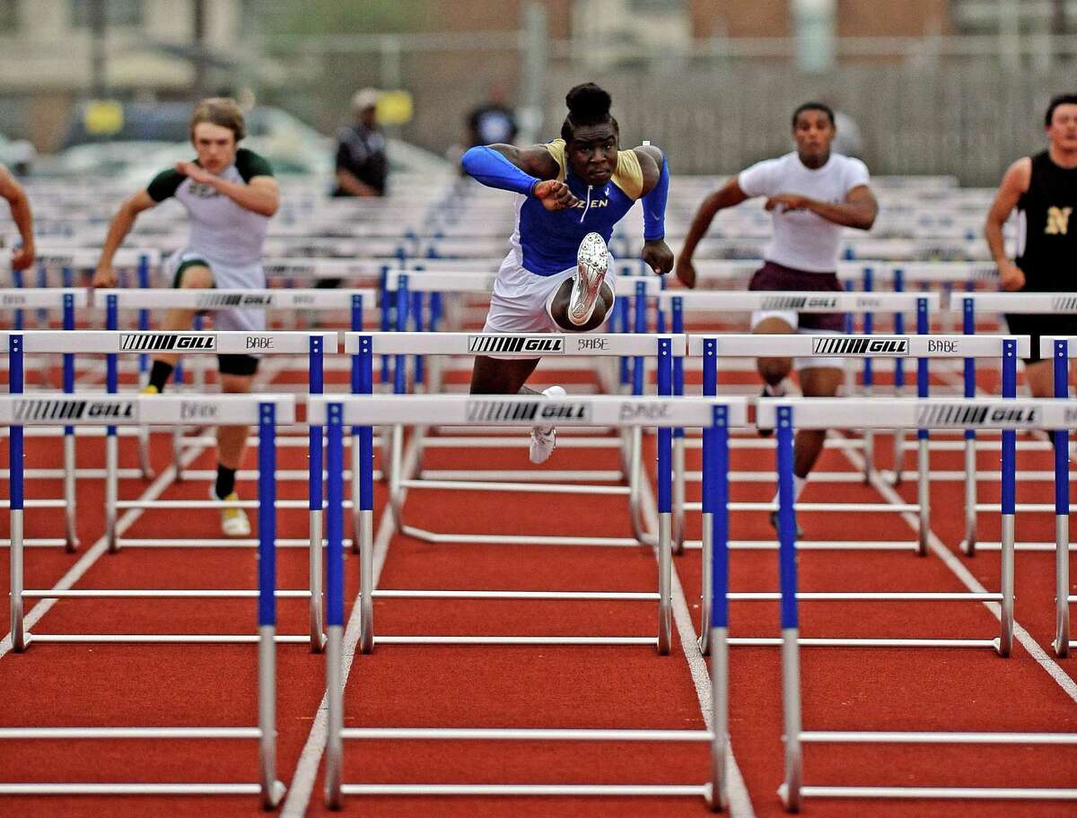 Ozen student Tony Brown, center, competes in the boys 110 meter hurdles at the UIL district 20-4A track and field championship on Wednesday, April 10, 2013, at Babe Zaharias Stadium. Photo taken: Randy Edwards/The Enterprise
