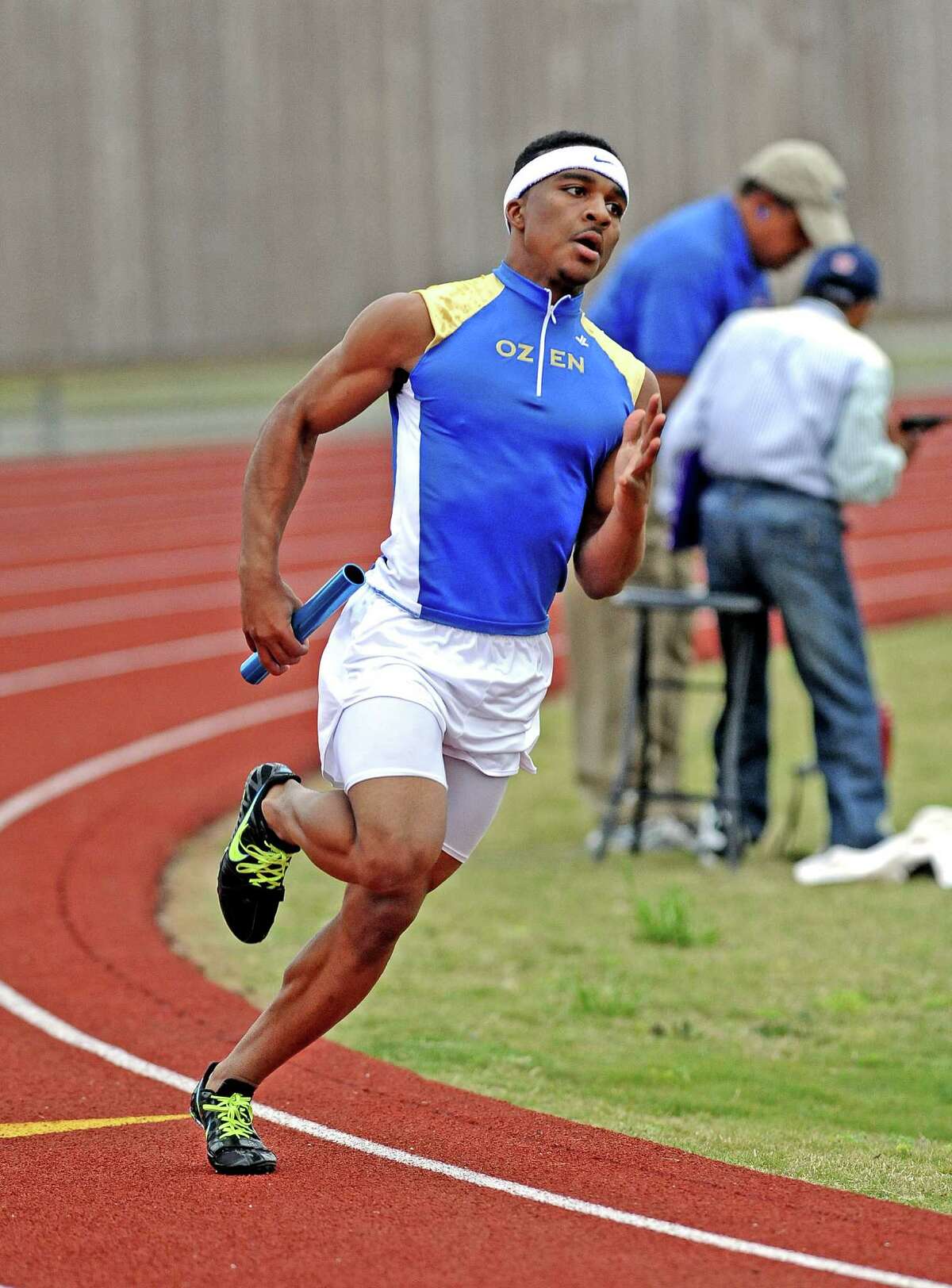 Ozen student Jakobi Jones takes the first leg of the boys 4 x 200 meter relay at the UIL district 20-4A track and field championship on Wednesday, April 10, 2013, at Babe Zaharias Stadium. Photo taken: Randy Edwards/The Enterprise