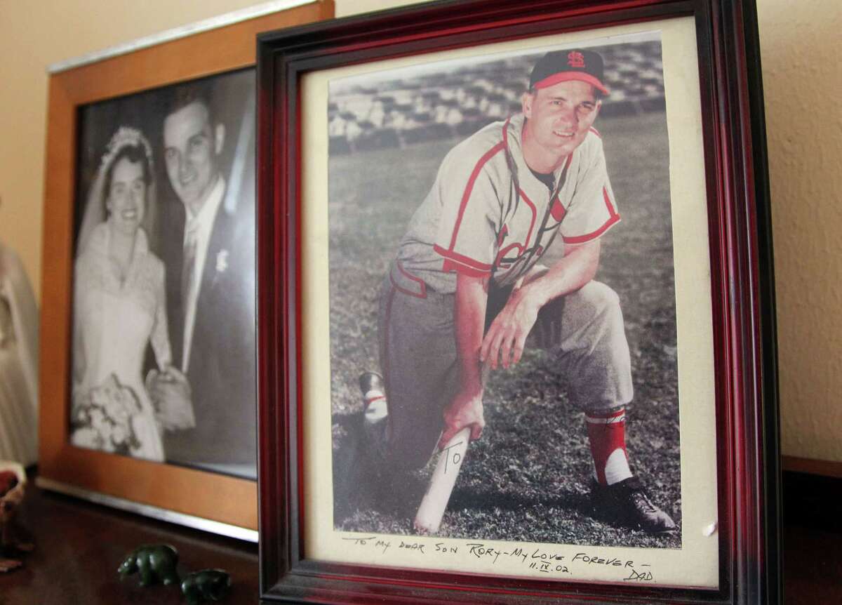 Treasured photos in the Miggins household include Larry and Kathleen's wedding day, and one of him in the St. Louis Cardinals uniform he wore after playing in Jersey City. He ended his career with the Houston Buffs.