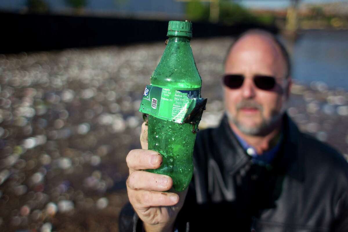 It's not hard for Robby Robinson of the Buffalo Bayou Partnership to find plastic bottles along the shoreline of Buffalo Bayou.