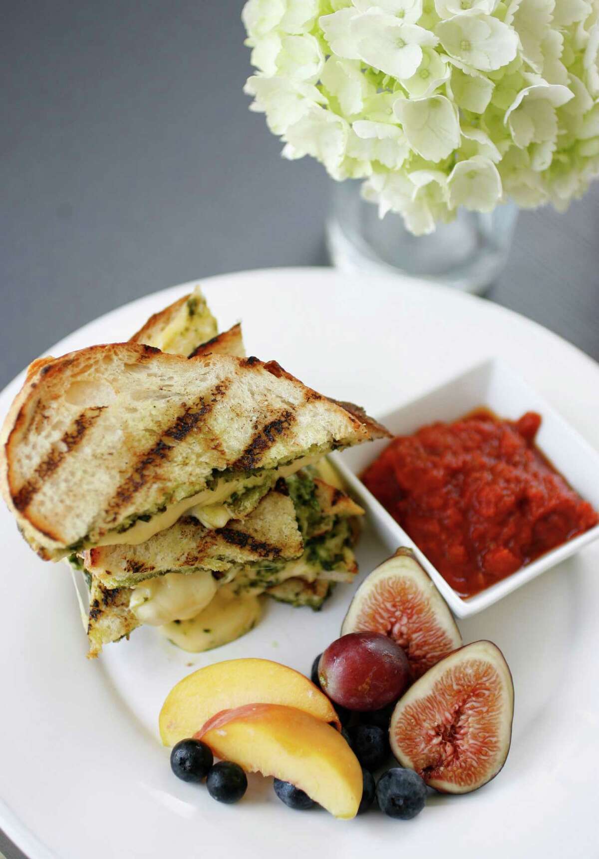 The grilled cheese and pesto sandwich on Pagnotta bread, with fruit and roasted tomato sauce, at Tiny Boxwood's Cafe (3614 W. Alabama), Saturday, July 12, 2008. For GLoss Places. ( Karen Warren / Chronicle )