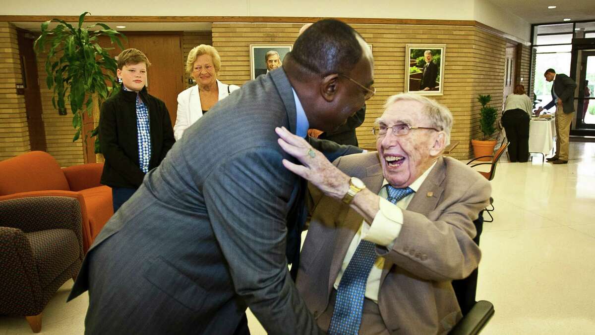 Victor Ilegdobu, M.D., left, says hello to James Steele, M.D., before Steele, who's turning 100 today, gives a lecture in the University of Texas, Houston School of Public Health, Tuesday, April 2, 2013, in Houston. Ilegdobu says he was a student under Steele in 1982 and calls Steele his instructor, advisor, father, everything. ( Nick de la Torre / Chronicle )