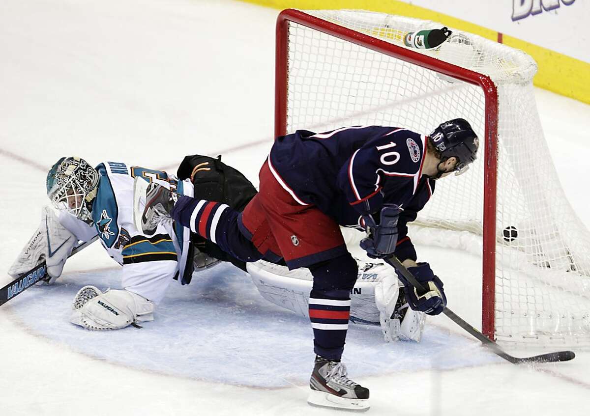 Columbus Blue Jackets' Marian Gaborik, right, of Slovakia, scores against San Jose Sharks goalie Antti Niemi, of Finland, during the third period of an NHL hockey game, Tuesday, April 9, 2013, in Columbus, Ohio. The Blue Jackets won 4-0. (AP Photo/Jay LaPrete)