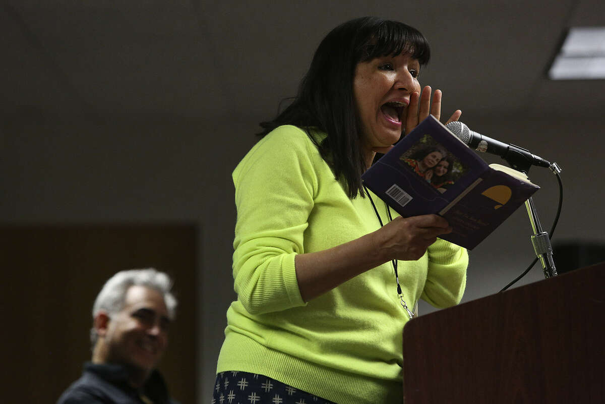 Sandra Cisneros reads from her book “Have You Seen Marie?” as moderator John Phillip Santos watches during the Texas Book Festival/San Antonio Edition at the Central Library.