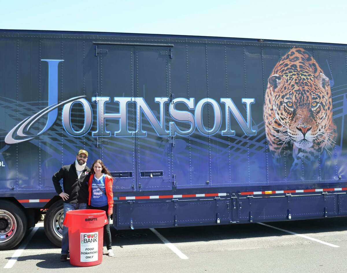 Eric Cooper, San Antonio Food Bank president/chief executive officer, and Johnson High School band officer Lauren Chaloupka were on hand for the ÒStuff the TrailerÓ event March 24 at the Stone Ridge H-E-B Plus store. Responding to an invite from the Jaguar band program, community members filled the trailer with 3,533 pounds of food to donate to the food bank. Event organizers also collected $735 in cash donations. The Band is preparing to perform in the Fiesta Battle of the Bands April 25 at Comalander Stadium, and will perform in the 2014 Tournament of Roses Parade. Visit www.johnsonjaguarband.org for details.