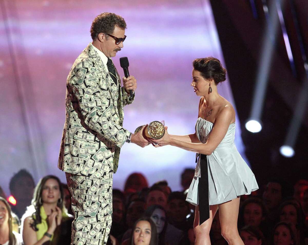 This April 14, 2013 photo shows actress Aubrey Plaza, right, as she tries to take away an award presented to Will Ferrell during the MTV Movie Awards in Culver City, Calif. Plaza approached the stage as Ferrell made his acceptance speech after winning the Comedic Genius award. (Photo by Matt Sayles/Invision /AP)
