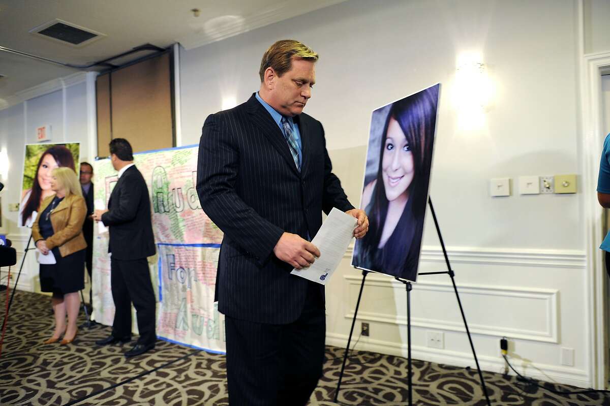 Audrie's father Larry Pott walks past a photo of his late daughter at the conclusion of a press conference at the Radisson Hotel in San Jose, CA Monday April 15th, 2013.