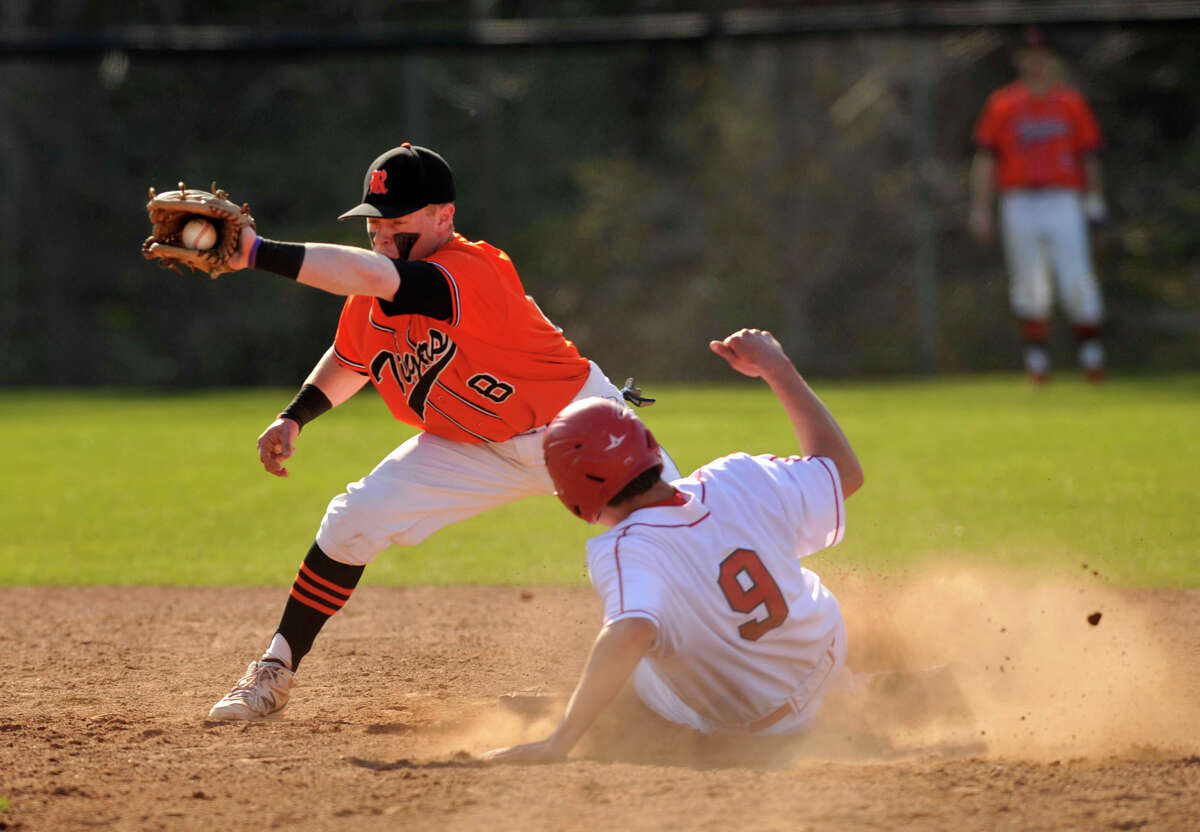 Greenwich's Liam O'Neil slides safely into second base beating the tag of Ridgefield shortstop Bryce Maher during their game at Greenwich High School on Monday, April 15, 2013. Greenwich won, 8-5.