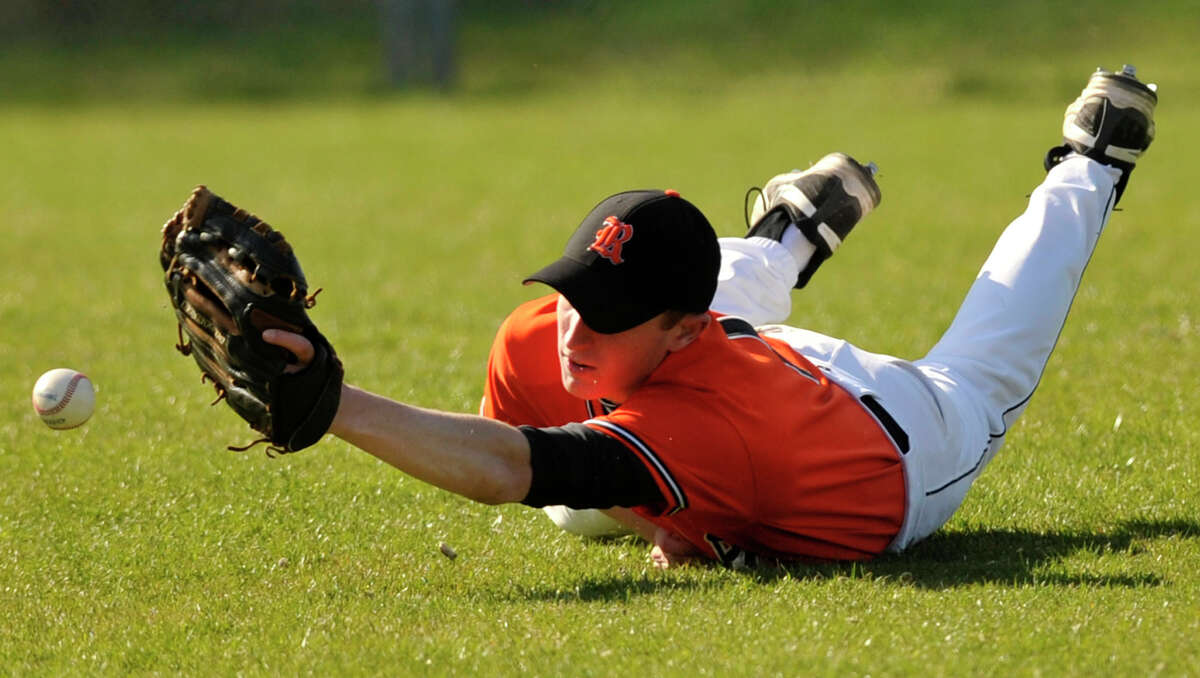Ridgefield right fielder Robert DePalma narrowly misses a diving catch during the Tigers' game against Greenwich at Greenwich High School on Monday, April 15, 2013. Greenwich won, 8-5.