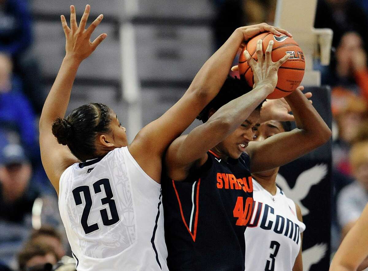 Connecticut's Kaleena Mosqueda-Lewis, left, and Syracuse's Kayla Alexander, right, battle for a rebound in the second half of an NCAA college basketball game in the semifinals of the Big East Conference women's tournament in Hartford, Conn., Monday, March 11, 2013. Connecticut won 64-51. (AP Photo/Jessica Hill)
