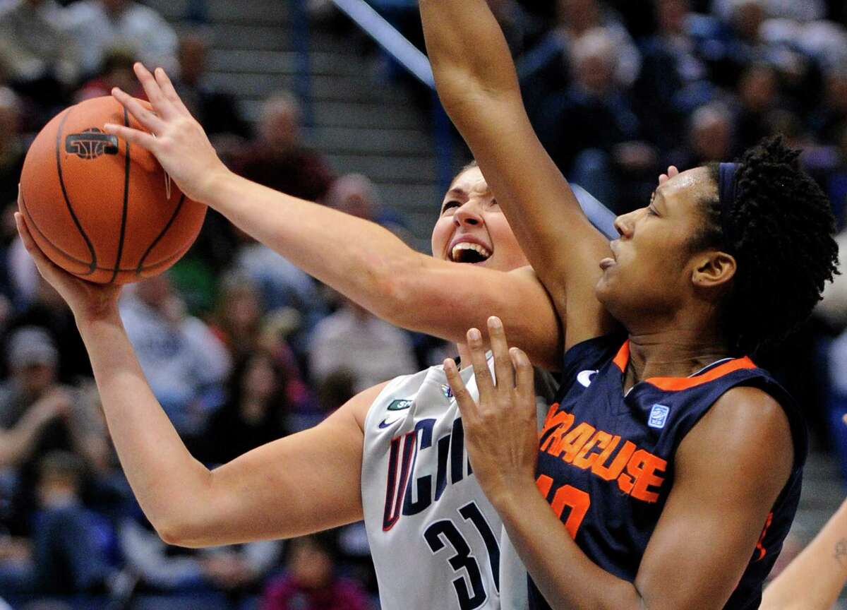 Connecticut's Stefanie Dolson, left, drives to the basket while being guarded by Syracuse's Kayla Alexander during the second half of an NCAA college basketball game in Hartford, Conn., Saturday, Jan. 19, 2013. Dolson scored a game-high 25 points in Connecticut's 87-62 victory. (AP Photo/Fred Beckham)