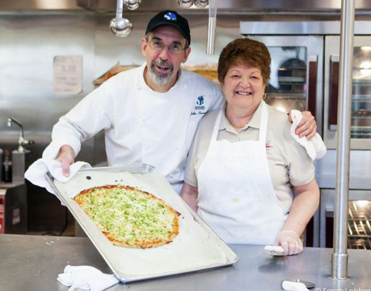 No more "mock pizza" in the new menus being developed at Fairfield public schools under guidance of consultant John Turenne, the founder and president of Sustainable Food Systems, shown with Pat Brienza, the manager/cook at McKinley School. The pizza served at the school is now the real thing with a whole-grain crust and topped with a five-vegetable tomato sauce.