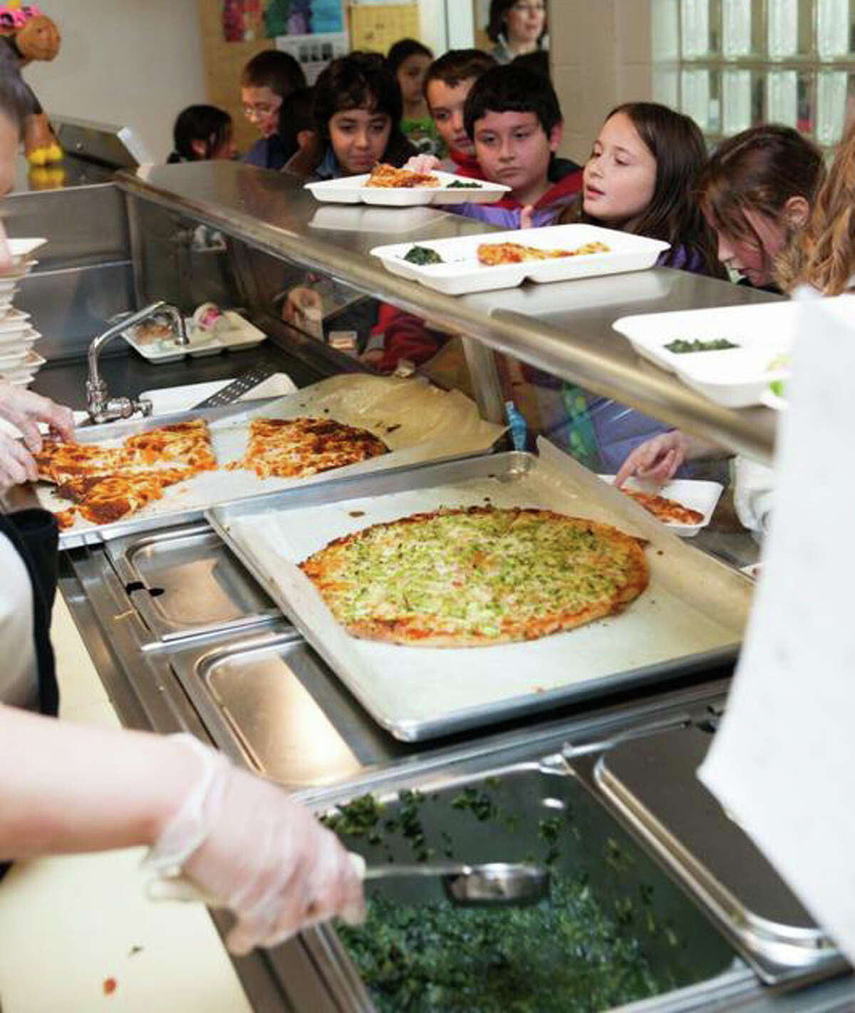 Students line up for lunch at McKinley School, one of two schools where new, healthier menus are being prepared and served under a pilot program this year.