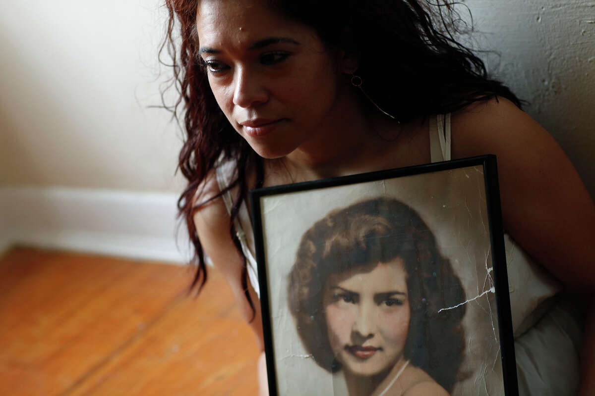 Cecilia Penix holds a photograph of her mother, Amelia Castillo, at Penix's home in San Antonio on Thursday, April 23, 2009. Cecilia was shot in the hand and her mother was killed by the sniper, Ira Attebury, during the 1979 Battle of Flowers Parade.