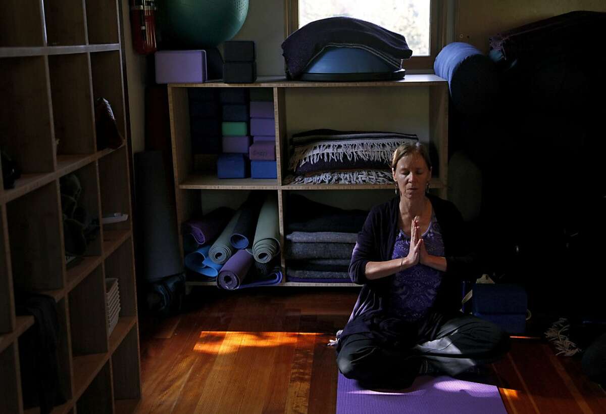 Cathy Harrington focuses on breathing during a class at Shakti Yoga Shala in Boulder Creek, Calif., on Friday, April 12, 2013.