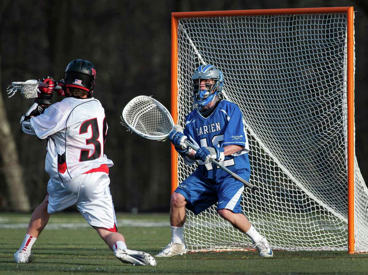 New Canaan high school's Michael Kraus winds up to take a shot on Darien high school goalie Phil Huffard in a boys lacrosse game played at New Canaan high school, New Canaan CT on Tuesday April 16th, 2013. Kraus scored a goal on this shot.