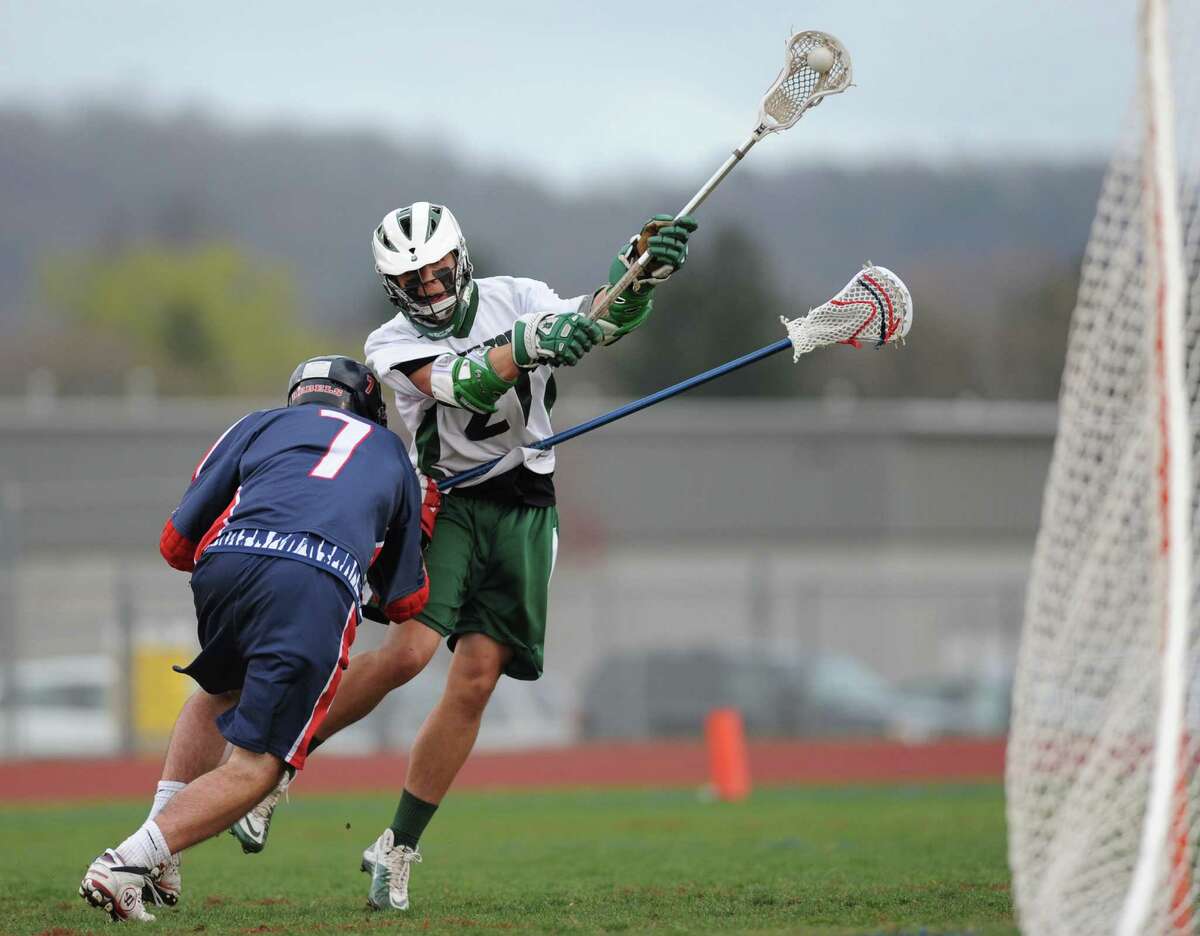 New Milford's AJ MacDonald shoots while defended by New Fairfield's Luke McFadden during New Milford's 8-7 overtime win against New Fairfield at New Milford High School in New Milford, Conn. on Tuesday, April 16, 2013.