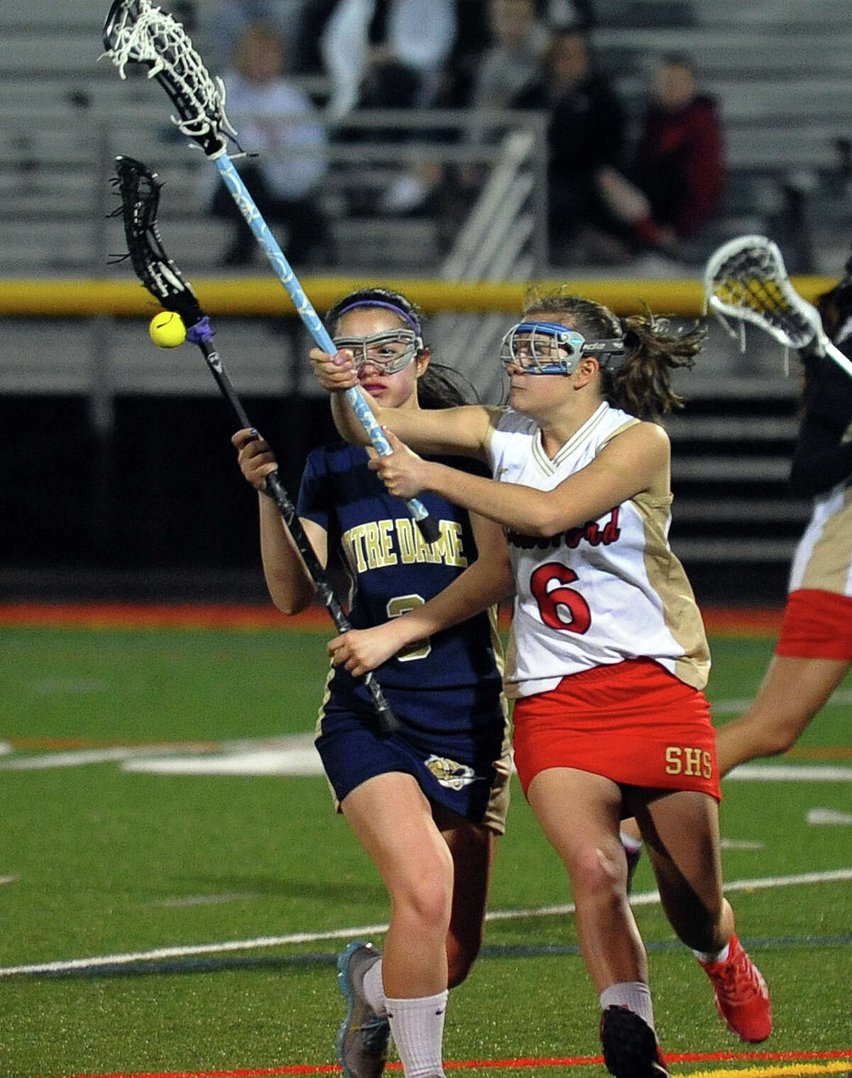 Stratford's Quincy Cayton, right, disrupts a drive by Notre Dame of Fairfield's Brianna Foster, during girls lacrosse action in Stratford, Conn. on Tuesday April 16, 2013.