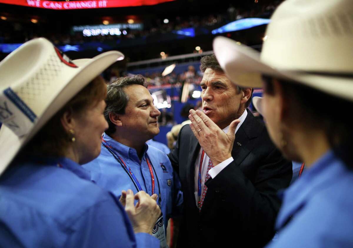TAMPA, FL - AUGUST 29: Rosemary Edwards of Austin, Texas and Steve Monisteri talk with Texas Gov. Rick Perry during the third day of the Republican National Convention at the Tampa Bay Times Forum on August 29, 2012 in Tampa, Florida. Former Massachusetts Gov. Mitt Romney was nominated as the Republican presidential candidate during the RNC, which is scheduled to conclude August 30.