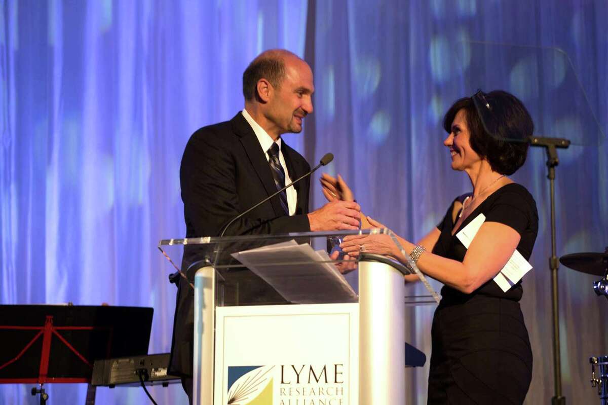 Dr. Mark Eshoo, director of new technology at Ibis Biosciences, received the Lauren F. Brooks Hope award for his groundbreaking research from Dr. Harriet Kotsoris, Chief Scientific Officer and head of Lyme Research Alliance's Scientific Advisory Board at the organization's recent gala.
