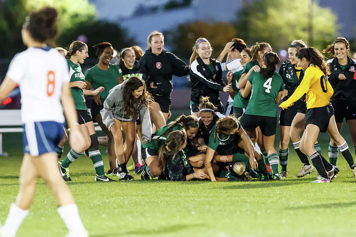 The Reagan Lady Rattlers celebrate their 2-1 overtime victory over Brandesis in their Class 5A second round playoff game at Northside ISD field No. 1 on Friday, April 5, 2013. Photo by Marvin Pfeiffer / Prime Time Newspapers