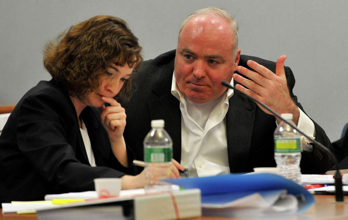 Michael Skakel, right, speaks to Jessica Santos, one of his defense attorneys, at Skakel's habeas corpus hearing at State Superior Court in Rockville, Conn., on Wednesday, April 17, 2013.