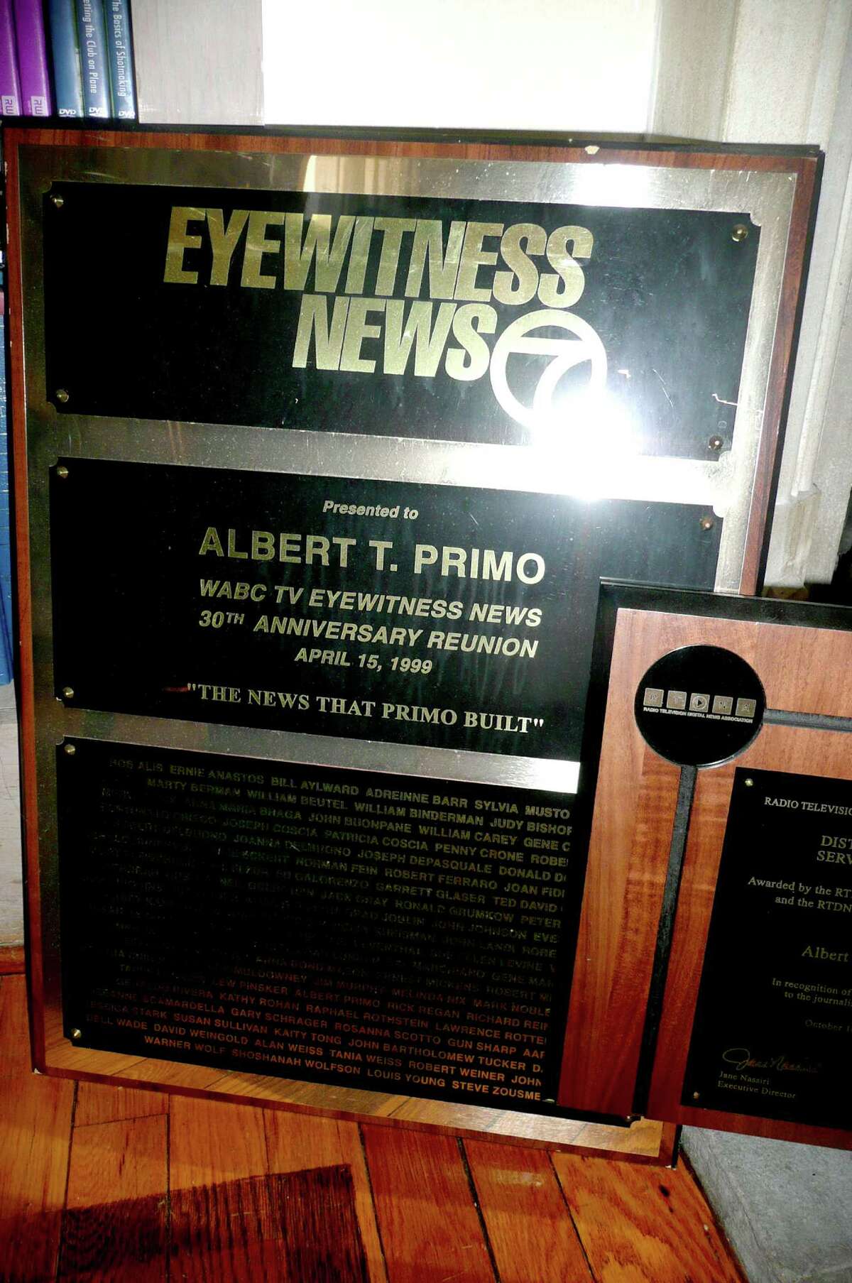 Al Primo received a plaque from the Eyewitness News team on the show's 30th anniversary. It read, in part, "The News that Promo Built."