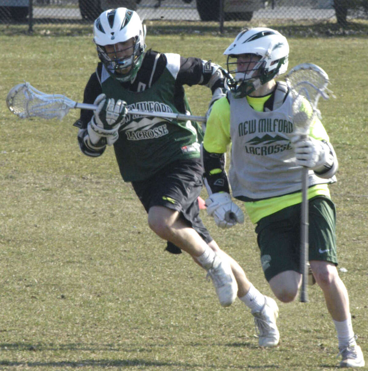 Blaine McMahon and A.J. McDonald of the Green Wave go at it 100 percent during practice for New Milford High School boys' lacrosse, April 2013