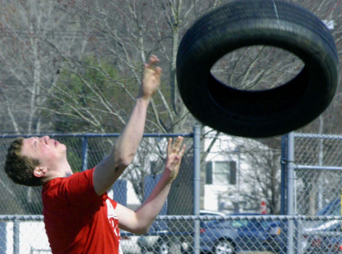 Green Wave veteran Jared Novicky flips a tire to help develop his potential for the throwing events for New Milford HIgh School boys' track, April 2013