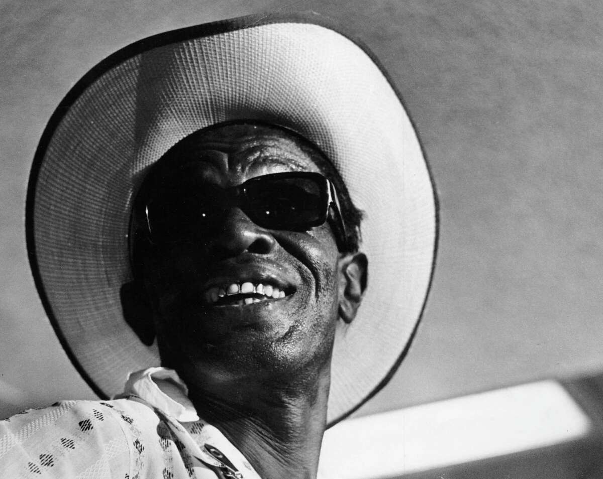 PHOTO FILED: SAM (LIGHTNIN') HOPKINS. 07/1967 - Blues artist Sam 'Lightnin' Hopkins performs at Jewish Community Center in Houston. Richard Pipes / Houston Chronicle HOUCHRON CAPTON (07/30/1967): NO CAPTION HOUCHRON CAPTION (03/31/2002): Hopkins wore a straw hat, shades and a smile when this photo was taken in 1967.