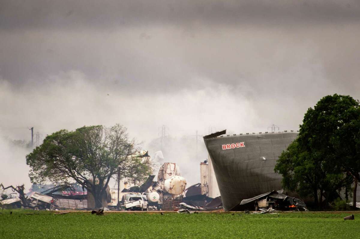 The remains of the the West Fertilizer Co. plant smolder in the rain on Thursday, April 18, 2013, in West, Texas. A massive explosion at the plant killed as many as 15 people and injured more than 160, officials said overnight. (AP Photo/Houston Chronicle, Smiley N. Pool) MANDATORY CREDIT