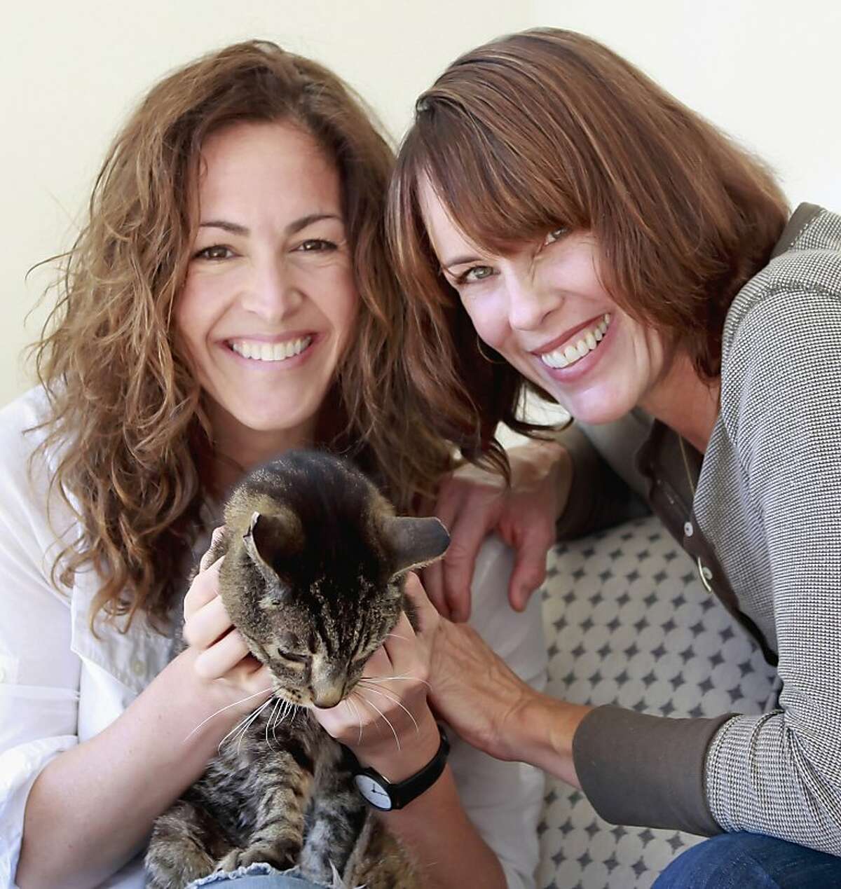 Illustrator Wendy MacNaughton and author Caroline Paul with their cat, Tibia