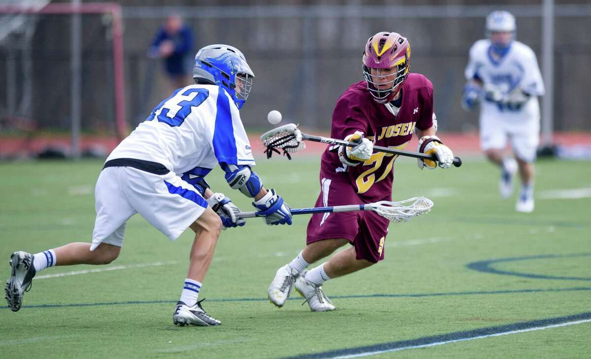 St. Joseph's Ryan Scinto reaches for a loose ball during Thursday's lacrosse game at Darien High School on April 18, 2013.
