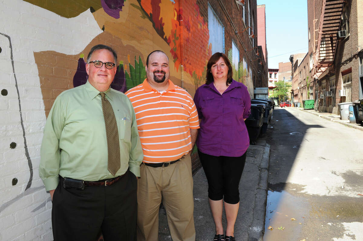 From left, Troy Planning Commissioner Bill Dunne, Charles Doyle, community development block grant outreach coordinator, and Dennee Zeigler, planning technician, stand in Franklin Alley Monday, Sept. 17, 2012 in Troy, N.Y. Dunne is is talking about transforming the alley into a pedestrian and dining area. (Lori Van Buren / Times Union)