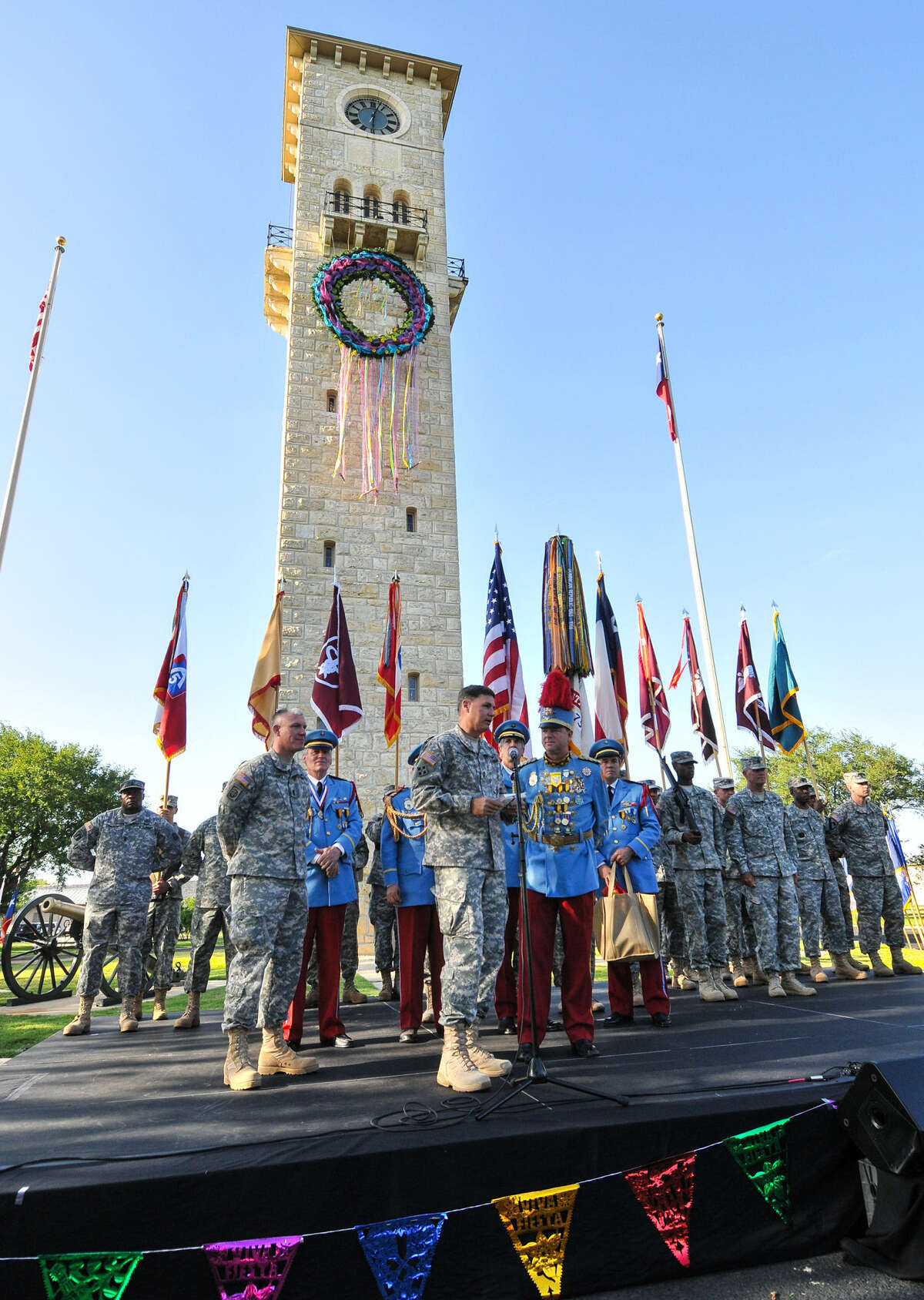 Maj. Gen. Frederick Rudesheim (at the microphone) presents King Antonio Steve Dutton with signed letters of appreciation from Army Command during the Joint Base San Antonio-Fort Sam Houston's Fiesta celebration.