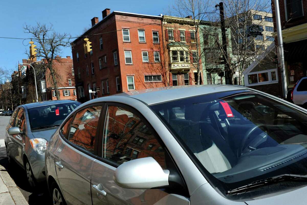 Red visitor parking tags hang on the rear view mirror of two cars parked in a row in Center Square on Wednesday, April 17, 2013, in Albany, N.Y. (Cindy Schultz / Times Union)