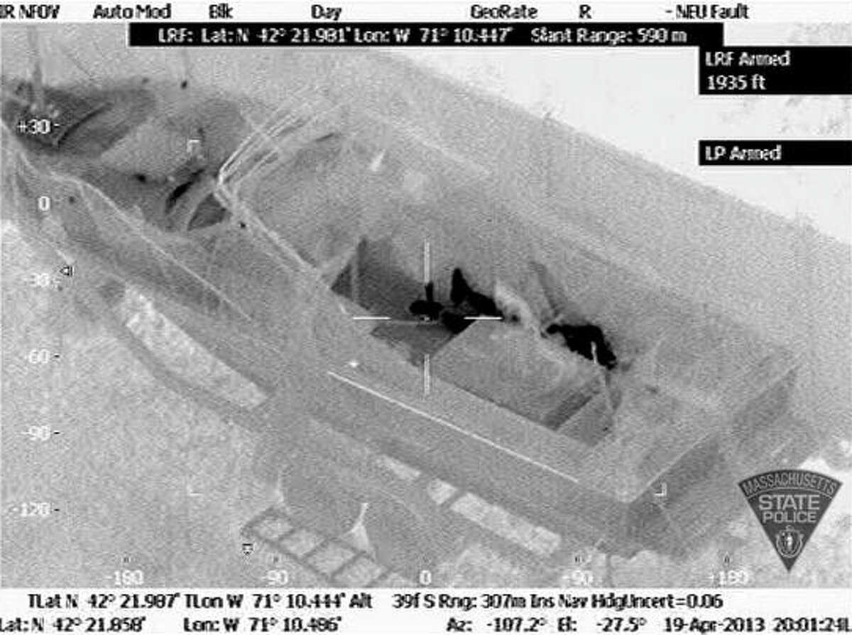 This Friday, April 19, 2013 image made available by the Massachusetts State Police shows 19-year-old Boston Marathon bombing suspect, Dzhokhar Tsarnaev, hiding inside a boat during a search for him in Watertown, Mass. He was pulled, wounded and bloody, from the boat parked in the backyard of a home in the Greater Boston area.
