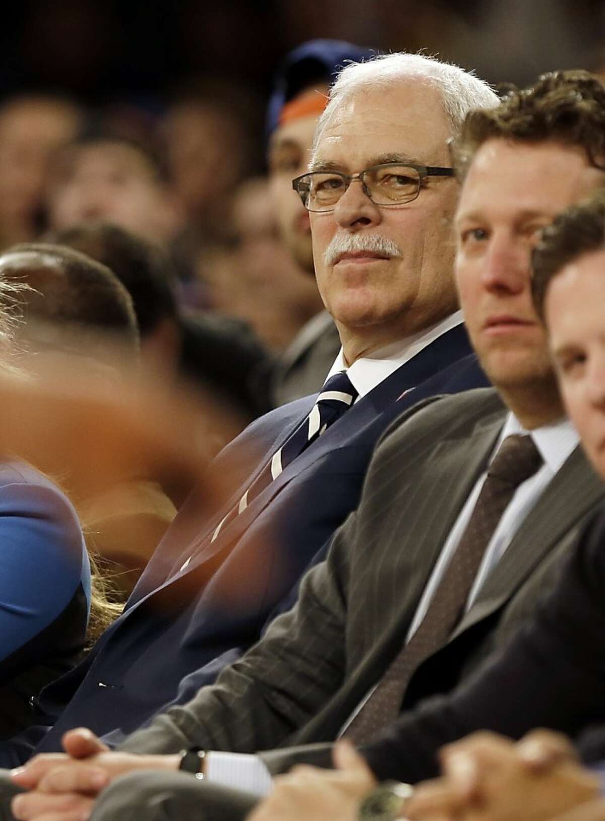 Former NBA coach Phil Jackson watches the first half of a basketball game between the New York Knicks and the Milwaukee Bucks, Friday, April 5, 2013, in New York. (AP Photo/Frank Franklin II)