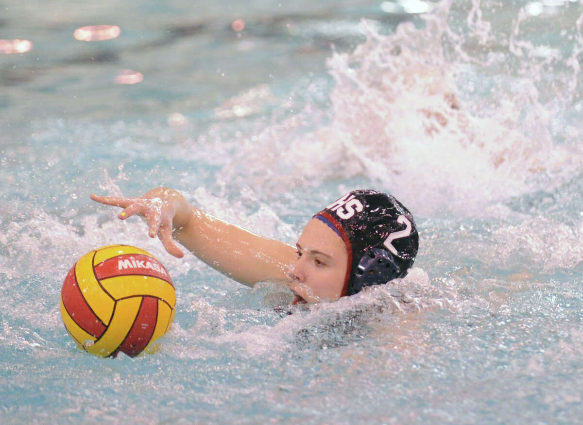 Paige Neary of Greenwich High School goes for the ball during water polo match against Staples High School at Greenwich, Tuesday, April 23, 2013.