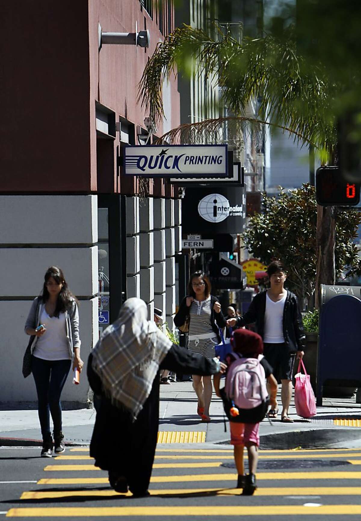 Pedestrians make their way through the crosswalk at the intersection of Polk Street and Bush Streets in San Francisco, Calif., on Tuesday, April 23, 2013. The Walk About Town column is about a project to improve Polk Street's walkability, where shoppers and pedestrians could get better safety in intersections and on the crowded sidewalks on Polk Street near Geary and Pine Streets.